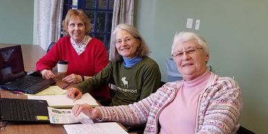 Three members of Friends of Peace Park Sheboygan are working on a project for the Park.