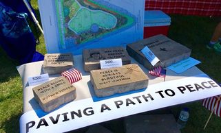 The photo shows a variety of paver blocks with messages engraved on them.