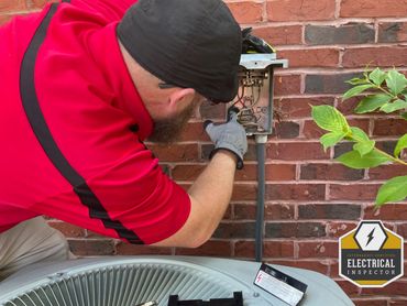 Jeremy Martin performing an inspection on the HVAC electrical disconnect box