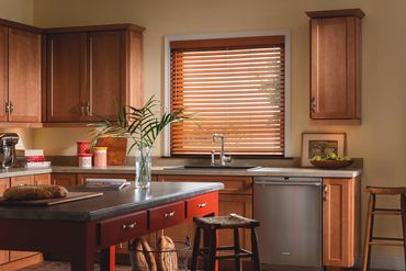 Custom stained wood window blinds designed to match kitchen cabinets for a coordinated look