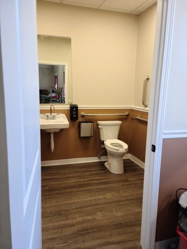 Handicap accessible bathroom with baby changing station