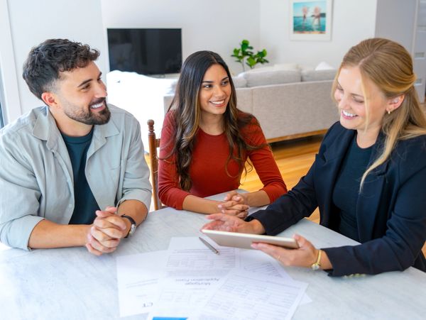 Insurance, finance or real estate agent with couple looking through documents.