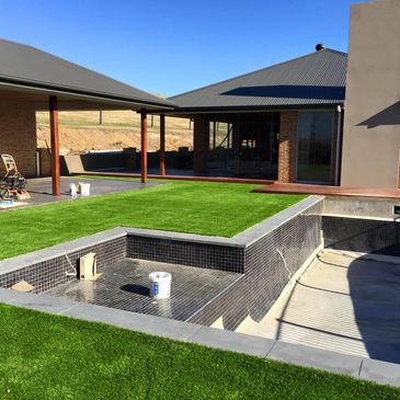 synthetic turf in backyard area pool