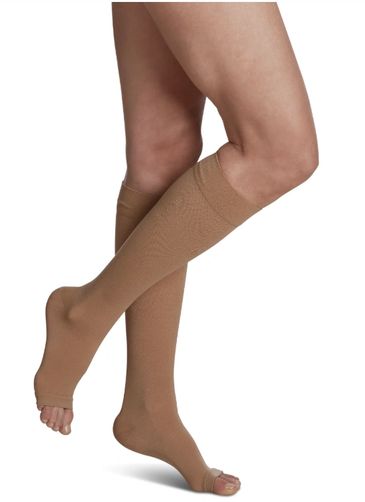 Person wearing beige open-toe compression socks.