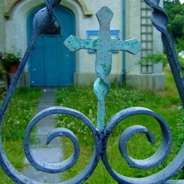 Wrought iron gate leads into an old church yard