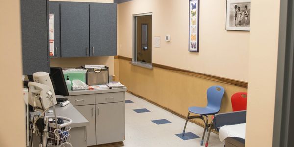 Empty medical examination room with chairs.