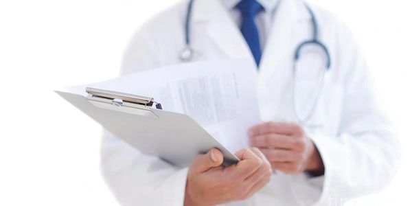 Doctor holding a clipboard with documents.