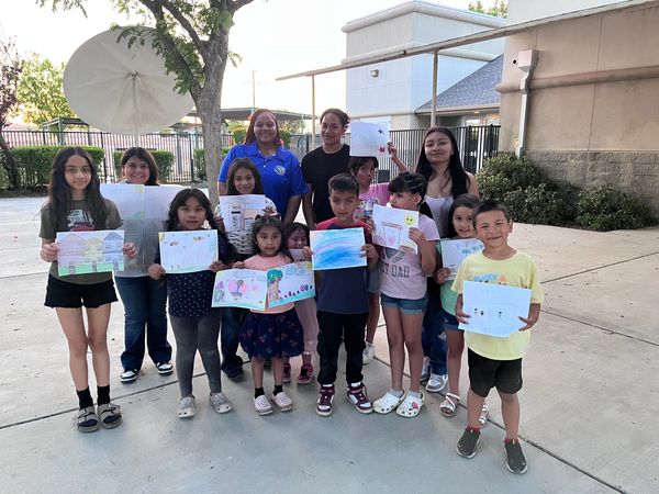 Group of Youth at our first Aclima meeting holding the pictures they drew.