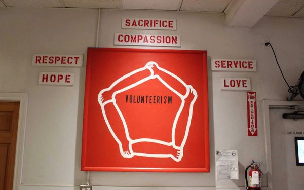 Red pentagon sign on wall.