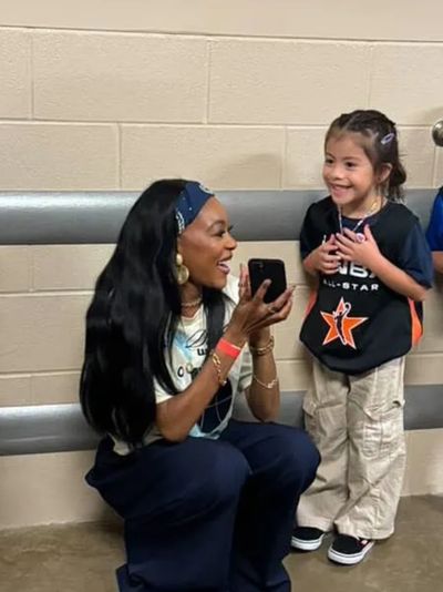 Woman happily talking to a smiling young girl.