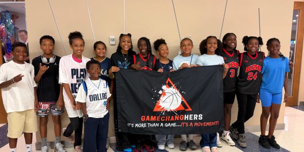 Group of kids holding a GameChangers banner.