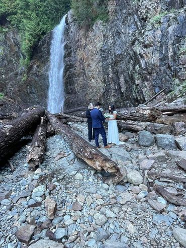 Young couple in love bride and groom, wedding day near waterfall