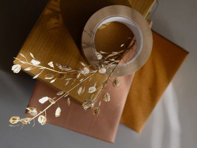 <img src="/images/sustainablewrappingitems.jpg" alt="Dried plant brown kraft paper and tape." />