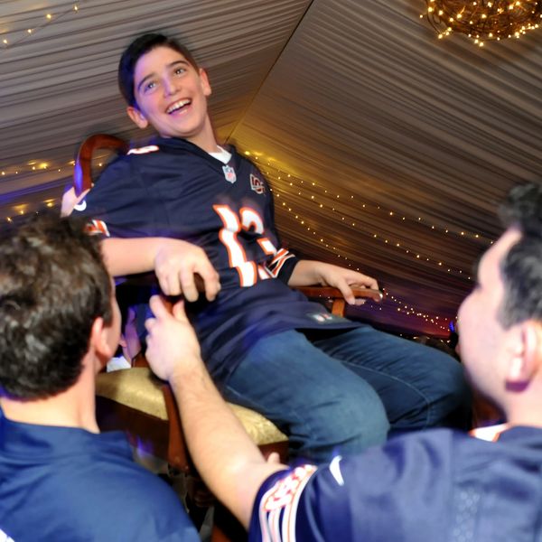 boy lifted on chair at bar mitzvah
