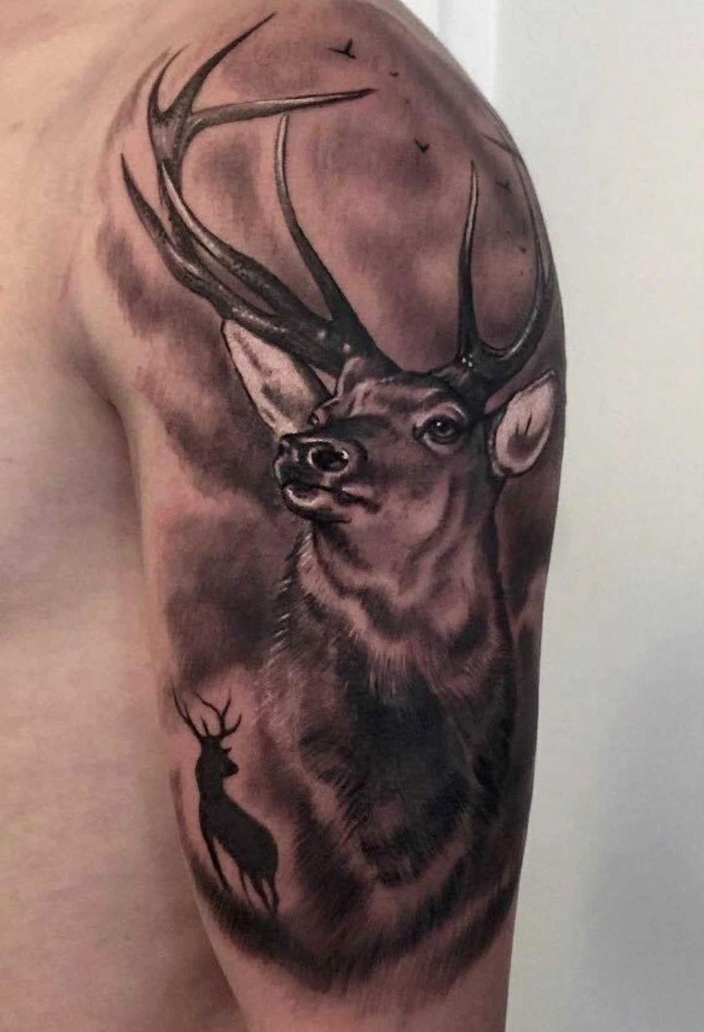 Realistic tattoo Stag with silhouette with scenery in black and grey Donny's own Tattoo Studio