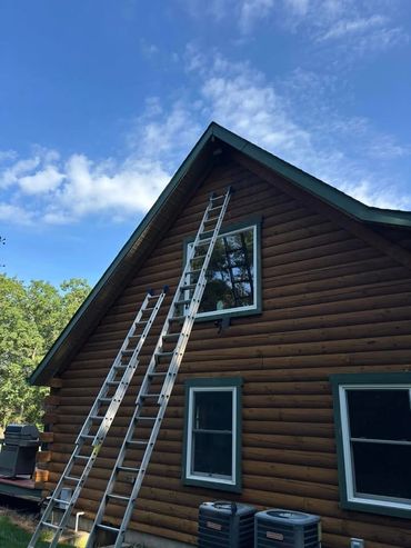 A house with two ladders leaned against it.