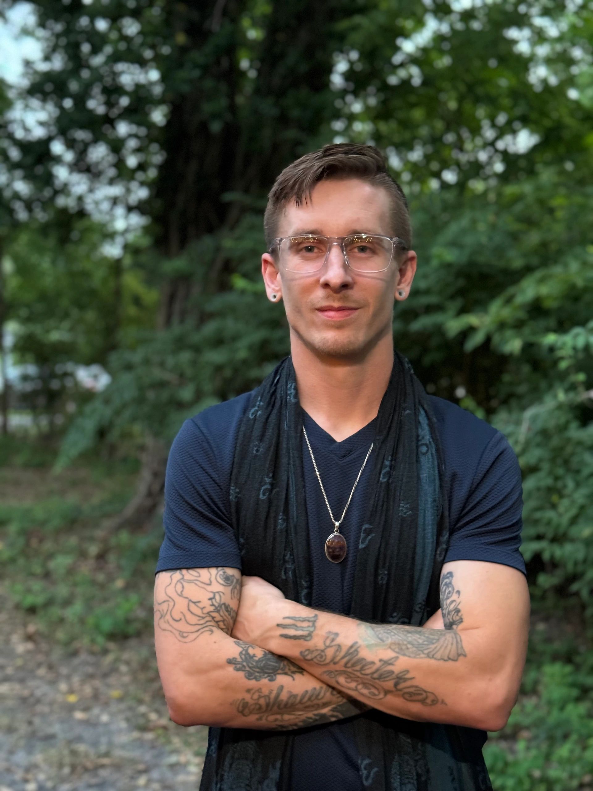 Zackery Taylor Allen with glasses on and arms crossed