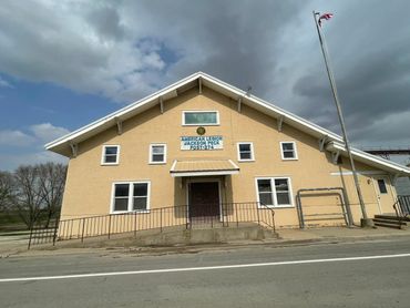 Front view of the American Legion Jackson Peck Post-274 building under a cloudy sky.