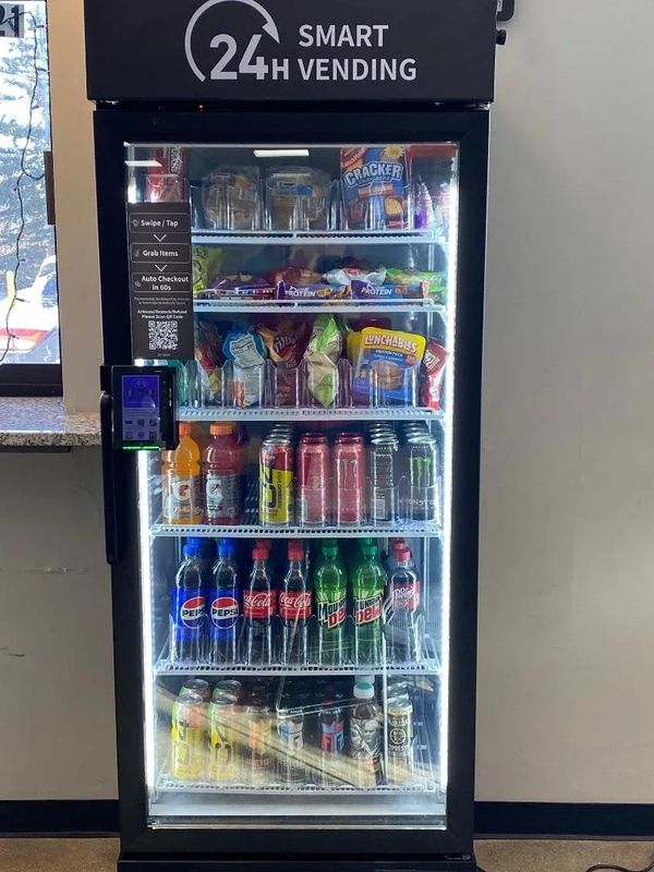 A well-stocked smart vending machine with snacks and drinks available 24/7.