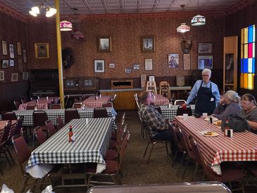 Cozy vintage diner with checkered tablecloths and rustic decor.