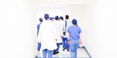 backside view of healthcare professional walking 
