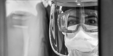 closeup of a person wearing safety glasses and mask 
