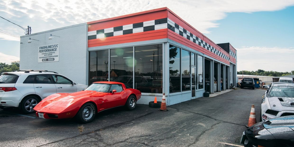 outside view of parking lot with cars parked in front of Finish Line shop