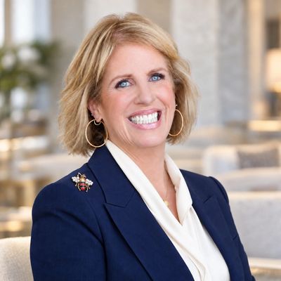 Smiling professional woman in business attire.