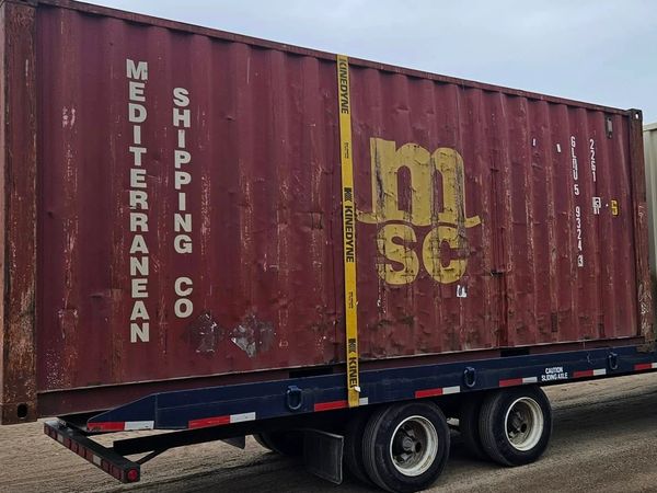 red 20ft used shipping container heading for North Dakota