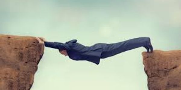 Aman stretching over a gap on a hill