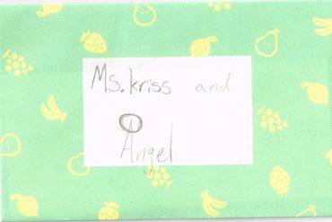 A handwritten note saying 'Ms. kriss and Angel' on a green background with fruit patterns.