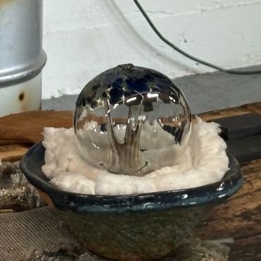 glass tree of life ornament hot out of the ovens