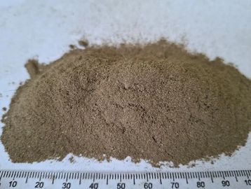 A pile of fine brown powder next to a ruler.