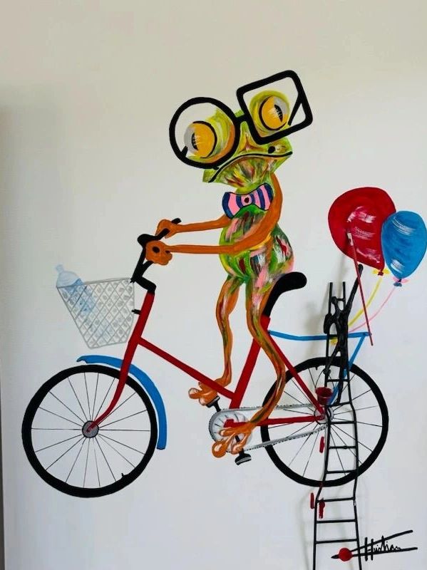 Lady frog on bicycle  with a bronze sculpture .