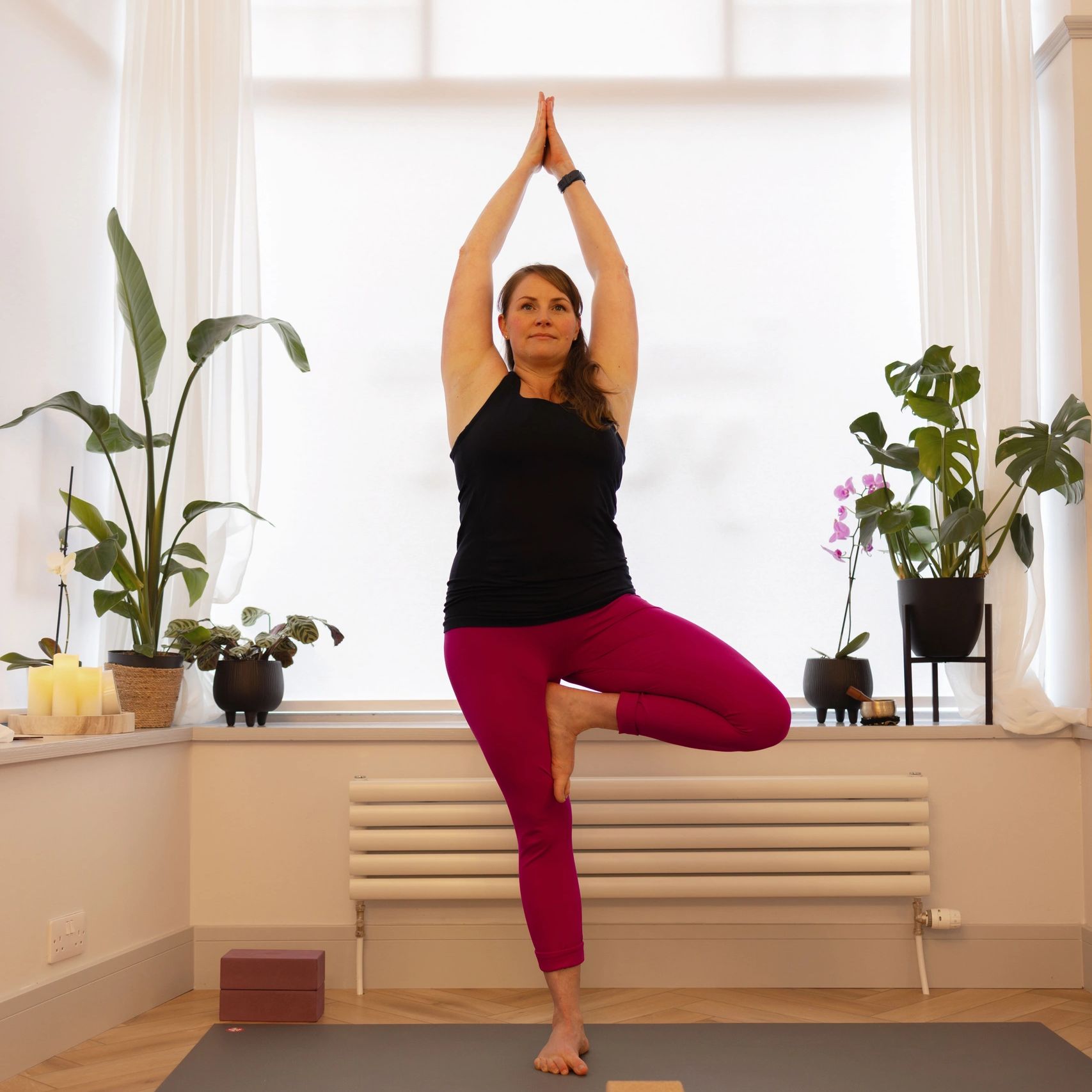Roxanna doing yoga tree pose in yoga studio in edinbugh