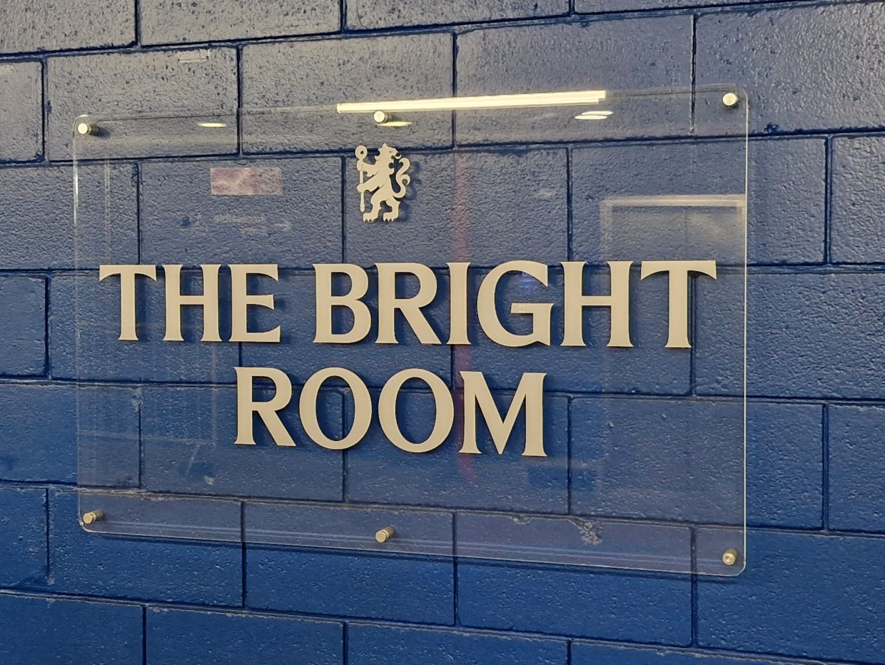 A sign saying The Bright Room, situated outside the Bright Room entrance.