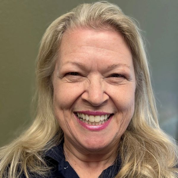Smiling elderly woman with blonde hair.