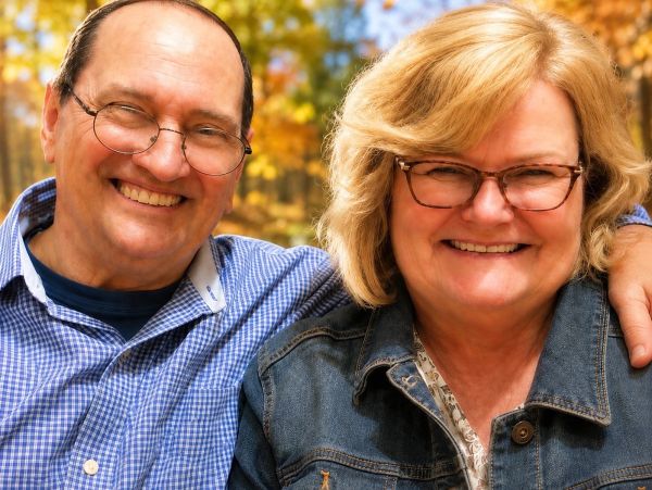 Smiling elderly couple outdoors in autumn.
