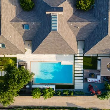 Aerial view of a house with a swimming pool and garden.