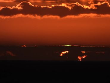 Fringing Green Flash above the horizon line before then sun has completely set from where you are,