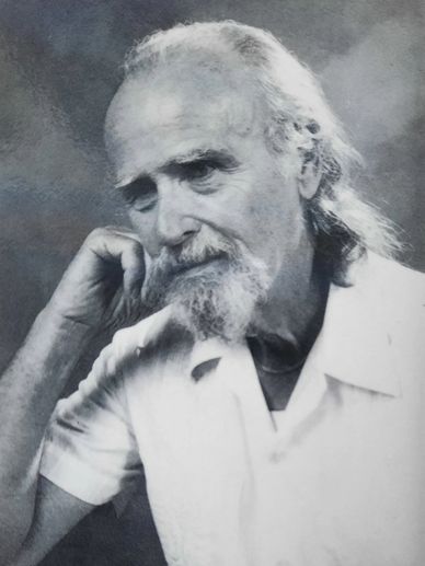 Black and white portrait of an elderly man with a thoughtful expression.