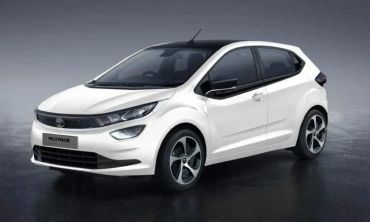 White compact hatchback car on a dark surface.