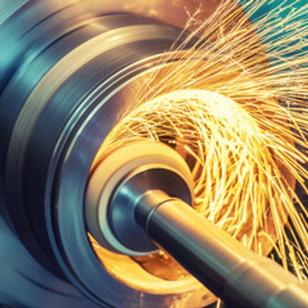 Machine tool grinding metal, sparks flying.