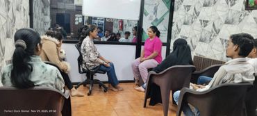 A group therapy session with participants seated in a circle discussing.