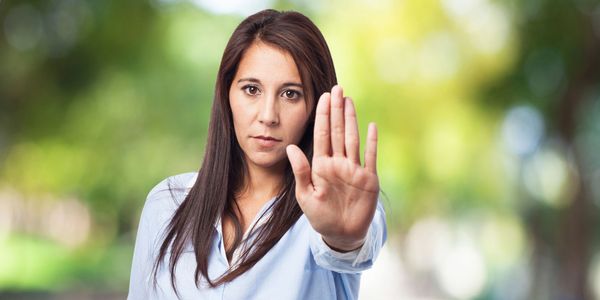 female hold palm out saying stop