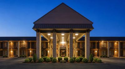 Hotel building entrance lit at twilight.