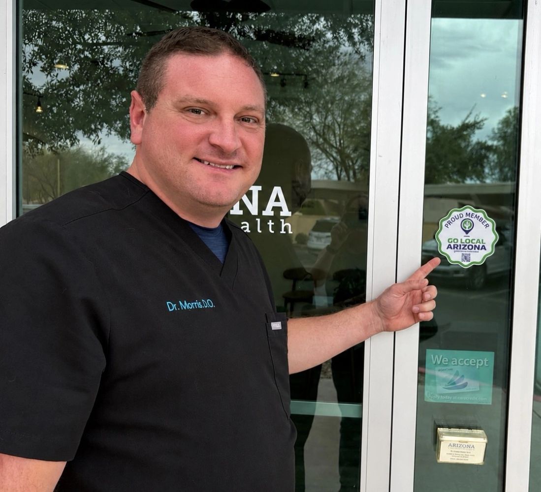 Dr. Chris Morris at Arizona Family Health in Surprise with Go Local AZ sticker.