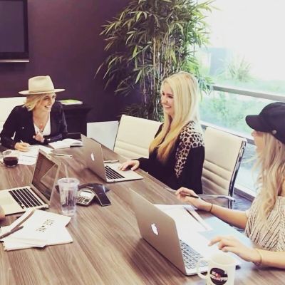 Three women collaborating in a modern office.