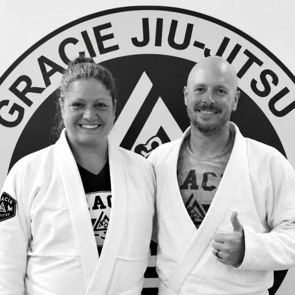 Two people in Gracie Jiu-Jitsu gi smiling.