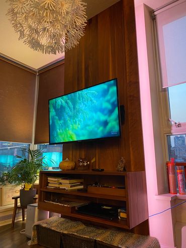 Black walnut TV wall with cabinet, internet and wireless router bay and adjustable color backlightin